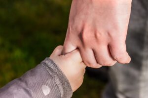 child and parents hand